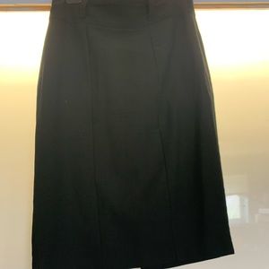 Black dressy skirt with belt loops. Small slit in back